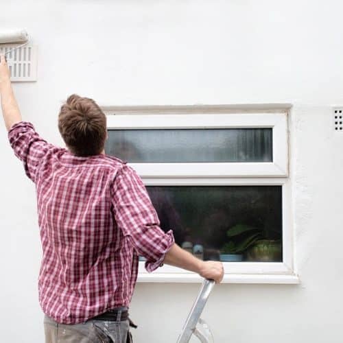 Painter painting by window