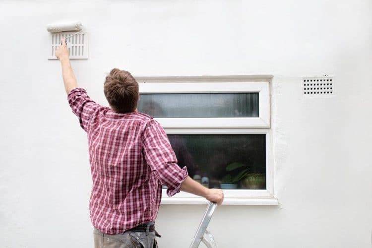 Painter painting by window