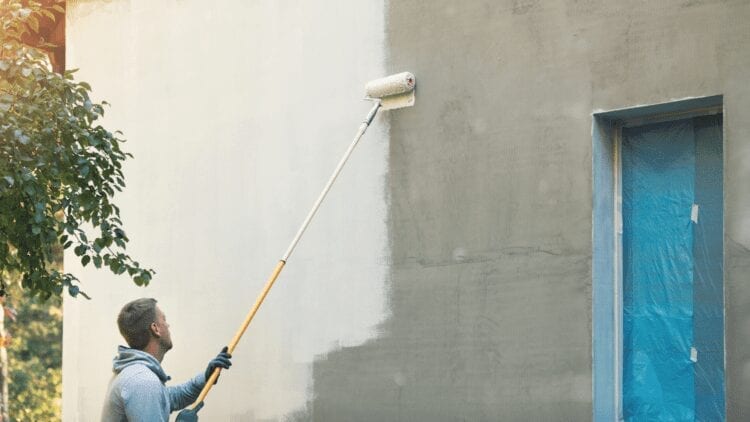 A man doing an exterior home painting job